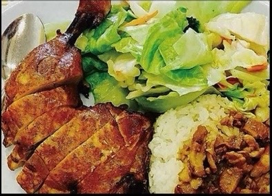 Roast duck served with jasmine rice and a fresh side salad